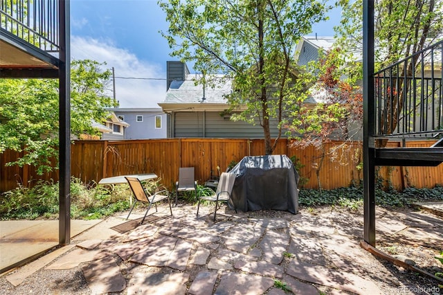 view of patio featuring a fenced backyard and a grill