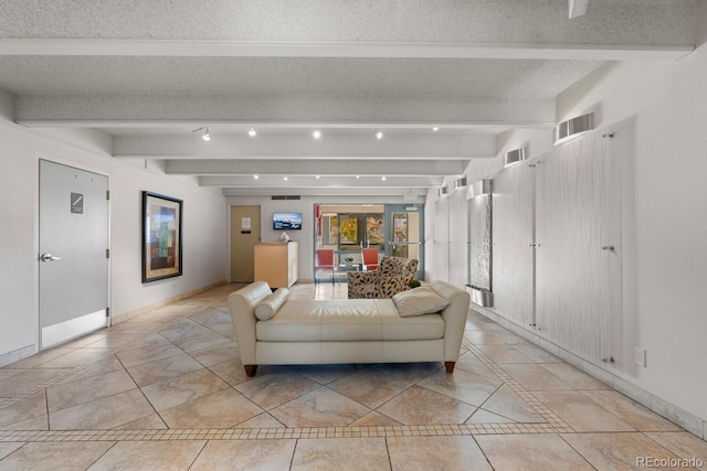 living room with beam ceiling, french doors, and a textured ceiling