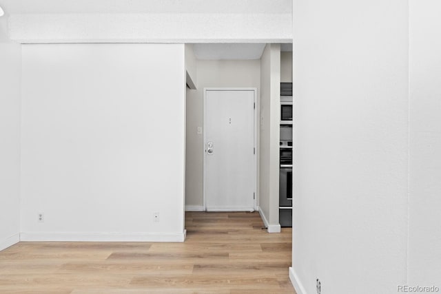 corridor featuring light hardwood / wood-style flooring