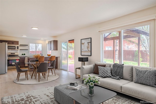 living room with a healthy amount of sunlight and concrete flooring