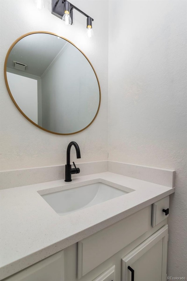 bathroom featuring crown molding and large vanity