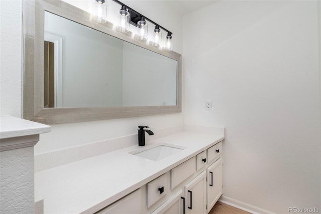 bathroom with hardwood / wood-style floors and vanity