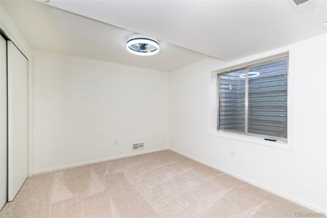 empty room with light colored carpet