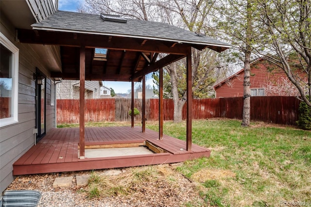 wooden terrace featuring a lawn