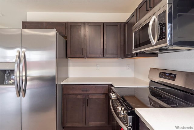 kitchen with appliances with stainless steel finishes and dark brown cabinets