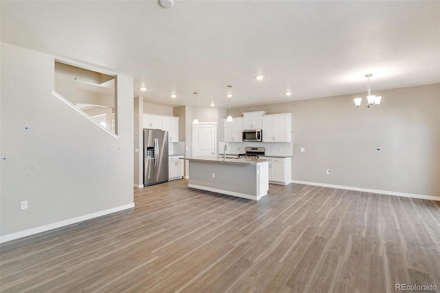 18358 Field Mint Pt, Parker, CO 80134 - kitchen featuring a kitchen island with sink, open floor plan, stainless steel appliances, and a sink