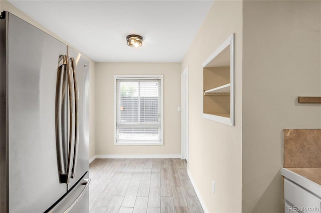 1264 Uinta St, Denver, CO 80220 - kitchen with freestanding refrigerator, baseboards, and light wood-type flooring