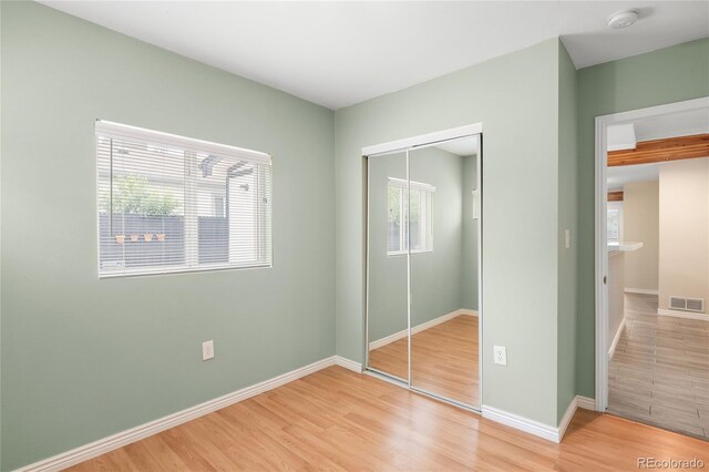 1264 Uinta St, Denver, CO 80220 - unfurnished bedroom with a closet, light wood-type flooring, and baseboards