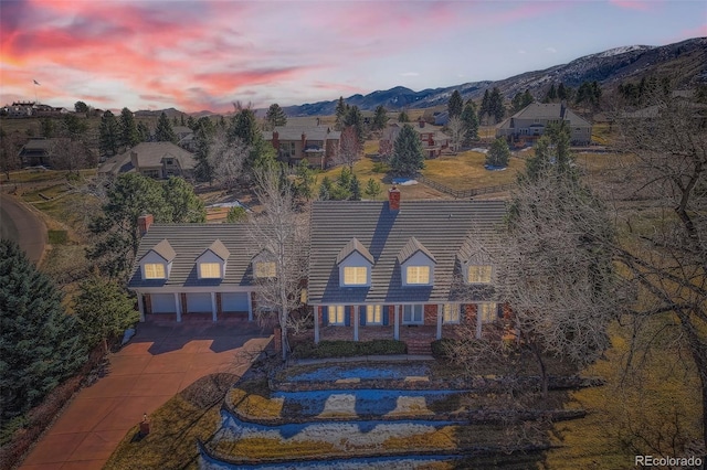 view of front of property featuring a mountain view, driveway, and an attached garage