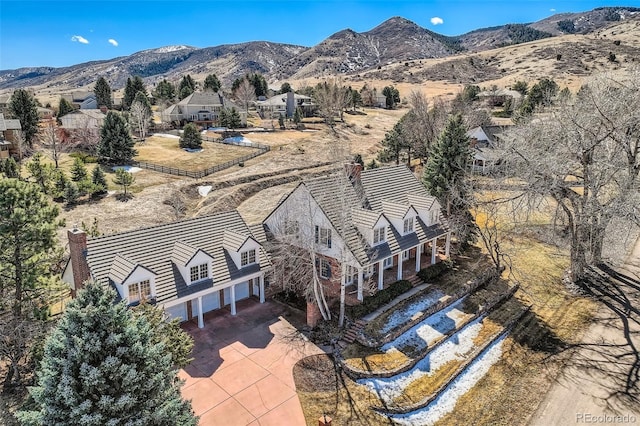 birds eye view of property with a mountain view