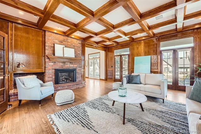 living room with french doors, coffered ceiling, and wood finished floors