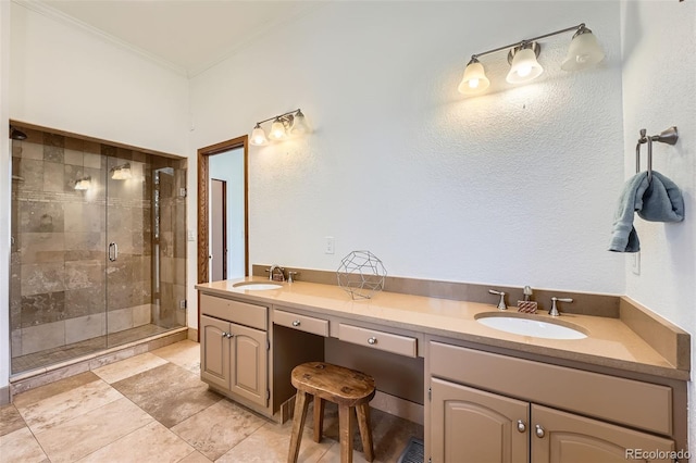 bathroom with double vanity, ornamental molding, a stall shower, and a sink