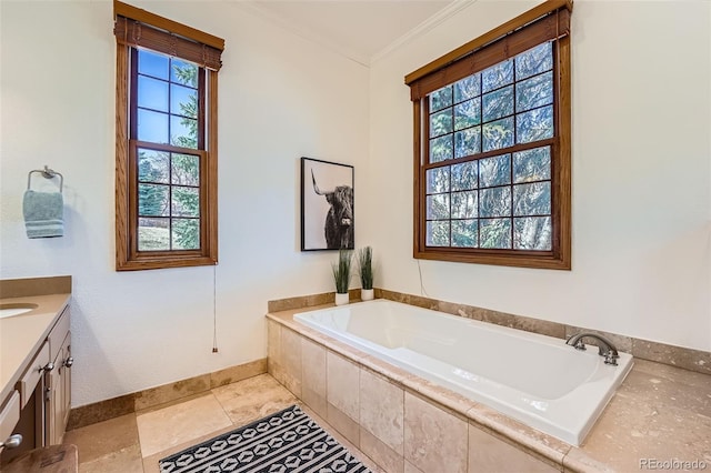 full bath featuring tile patterned floors, a garden tub, crown molding, baseboards, and vanity