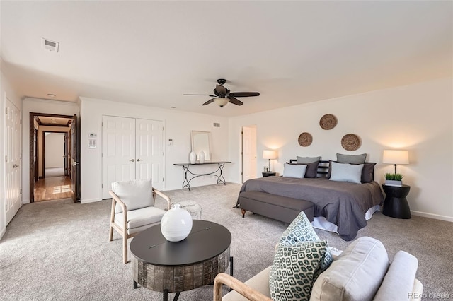 bedroom featuring visible vents, baseboards, ceiling fan, a closet, and light colored carpet