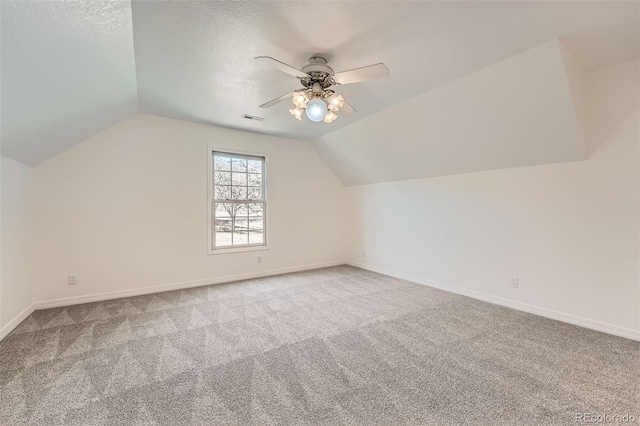 additional living space featuring baseboards, a ceiling fan, carpet flooring, and vaulted ceiling