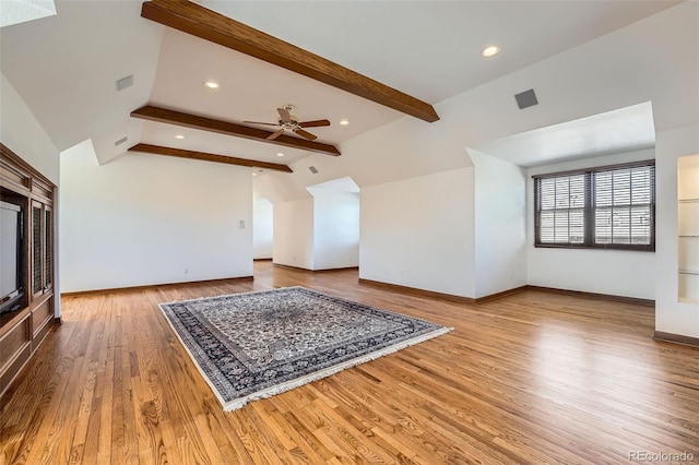 additional living space with wood finished floors, baseboards, visible vents, lofted ceiling with beams, and ceiling fan