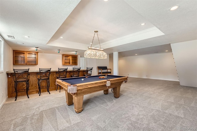 playroom with visible vents, a raised ceiling, light colored carpet, and a textured ceiling