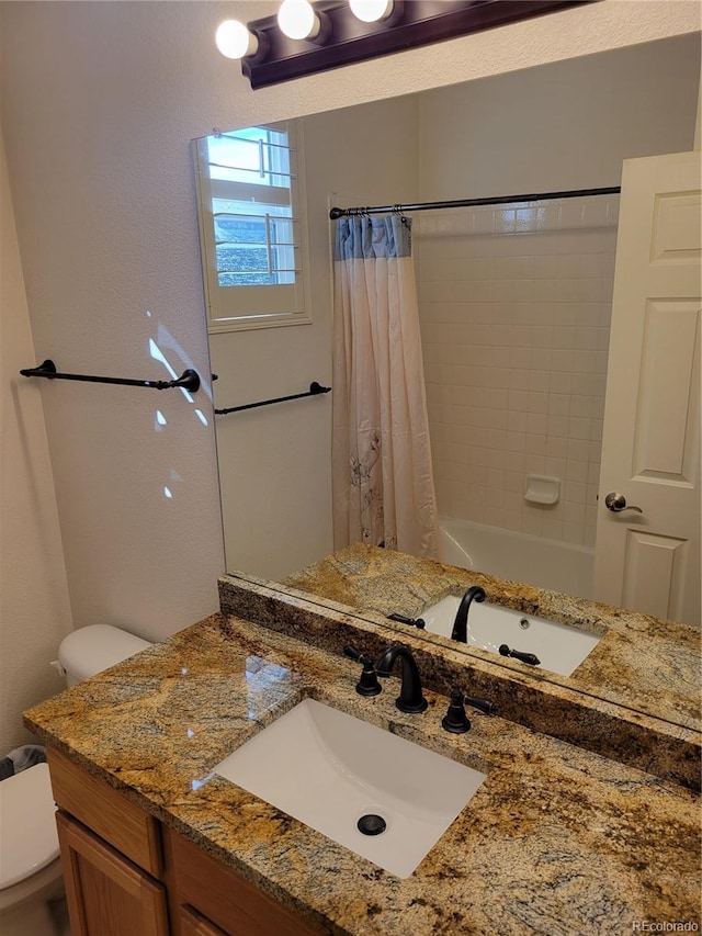 full bathroom with shower / bath combo, vanity, and toilet