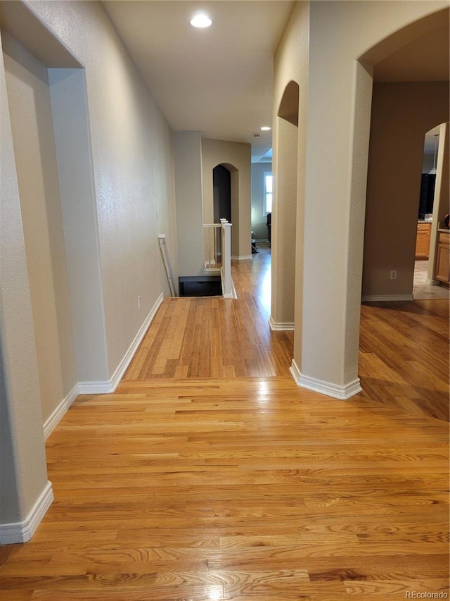 corridor with light wood-type flooring