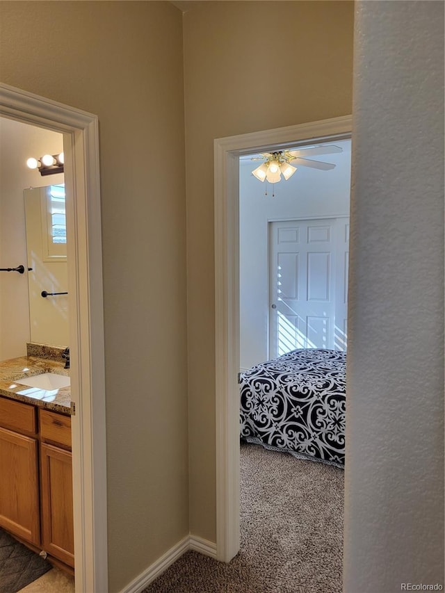 hallway with sink and carpet flooring