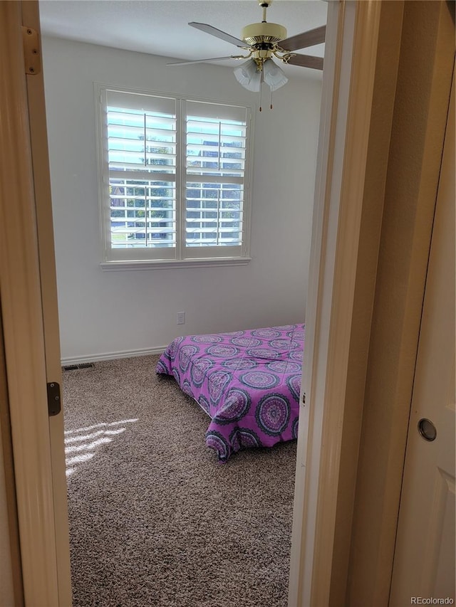 carpeted bedroom with ceiling fan