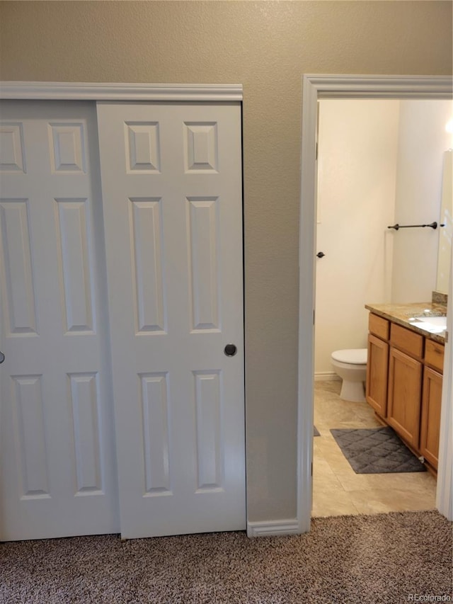 bathroom featuring vanity and toilet