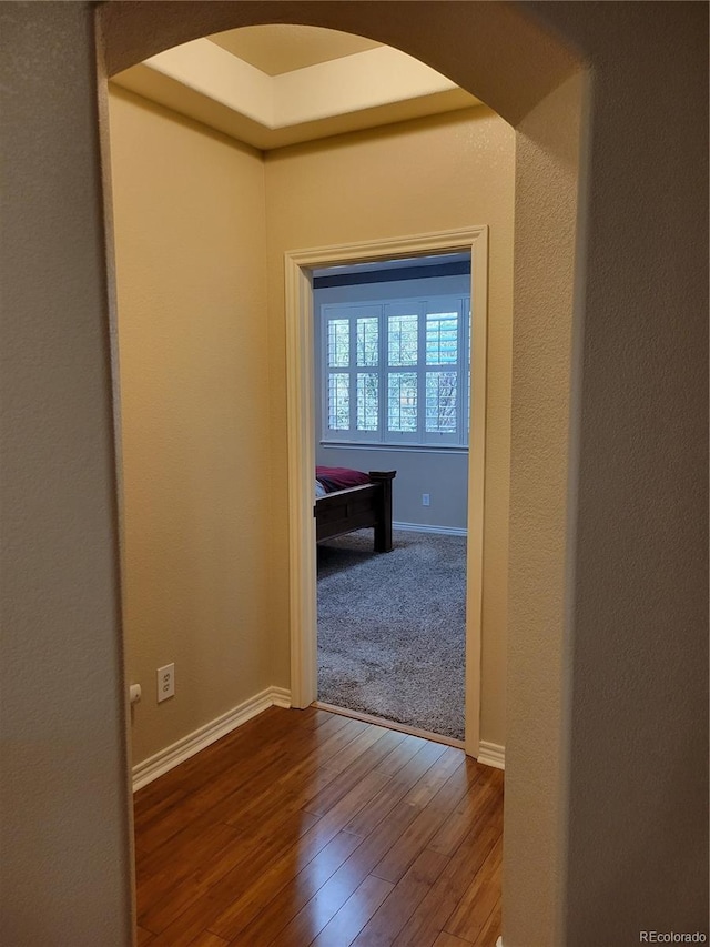 hallway with hardwood / wood-style flooring