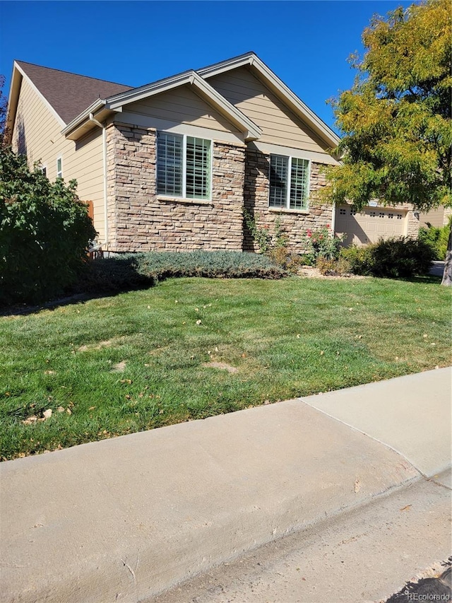 view of front of property featuring a garage and a front yard