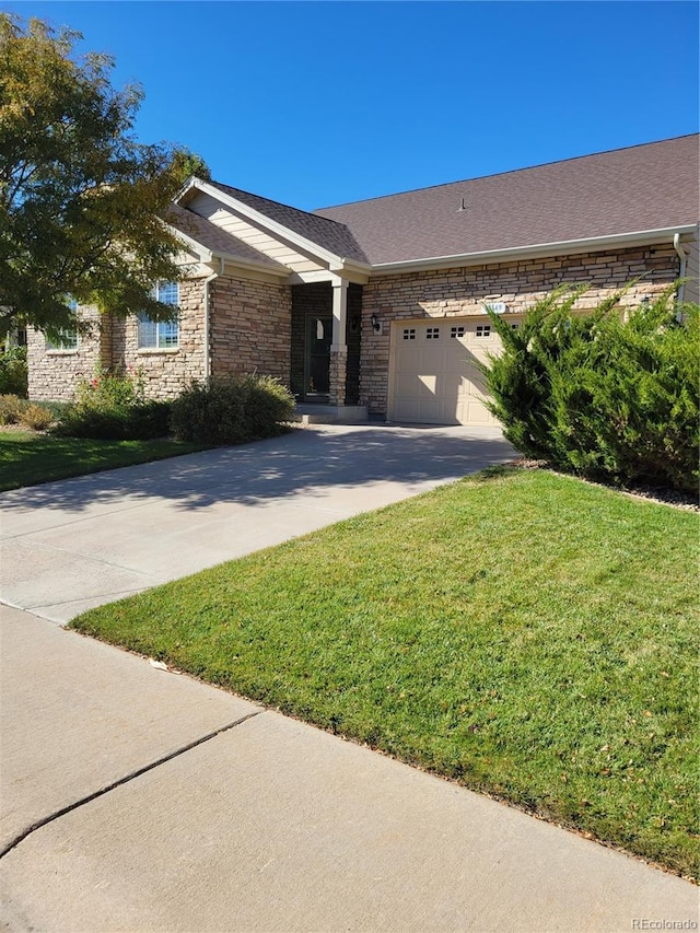 view of front of property with a garage and a front yard