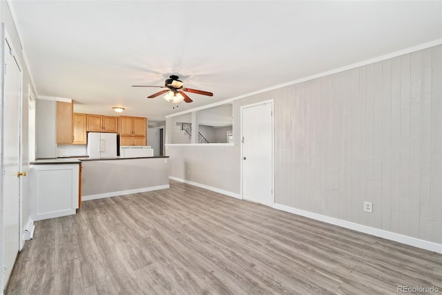 3270 W 92nd Pl, Westminster, CO 80031 - unfurnished living room featuring a ceiling fan, light wood finished floors, crown molding, and baseboards