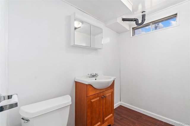 3270 W 92nd Pl, Westminster, CO 80031 - half bathroom featuring toilet, vanity, wood finished floors, and baseboards