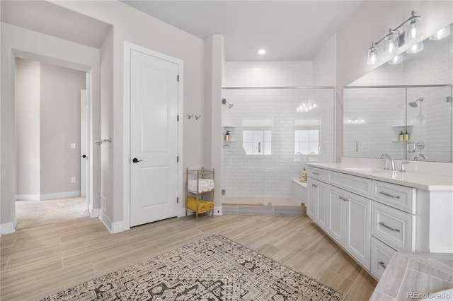 8691 S Sicily Ct, Aurora, CO 80016 - full bathroom featuring wood tiled floors, a shower stall, vanity, recessed lighting, and baseboards