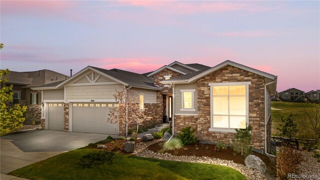 8691 S Sicily Ct, Aurora, CO 80016 - view of front of home with stone siding, an attached garage, concrete driveway, and a front lawn