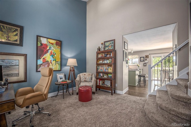 9200 W Indore Dr, Littleton, CO 80128 - sitting room featuring carpet, a towering ceiling, stairway, and an office area