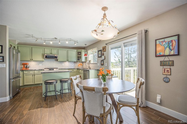 9200 W Indore Dr, Littleton, CO 80128 - dining area featuring dark wood finished floors and baseboards