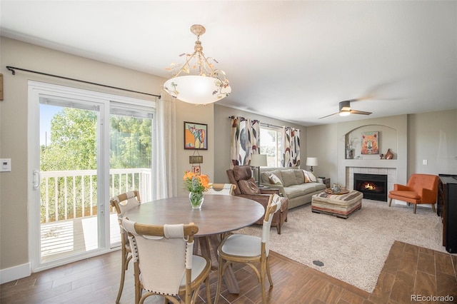 9200 W Indore Dr, Littleton, CO 80128 - dining room with a ceiling fan, wood finished floors, and a tile fireplace