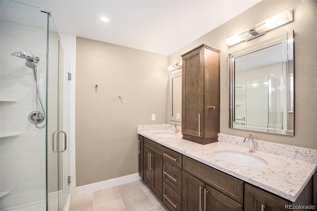 9200 W Indore Dr, Littleton, CO 80128 - full bathroom with double vanity, a stall shower, and tile patterned flooring