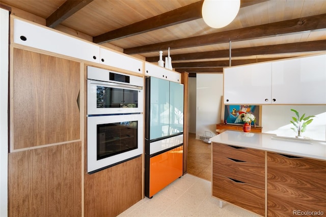 kitchen with white cabinets, beam ceiling, wooden ceiling, and double oven