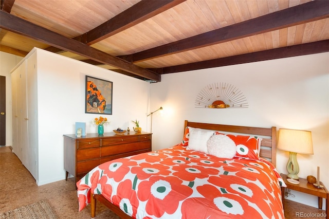 carpeted bedroom featuring beam ceiling and wooden ceiling