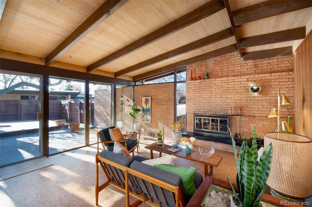 sunroom / solarium with an outdoor brick fireplace and vaulted ceiling with beams