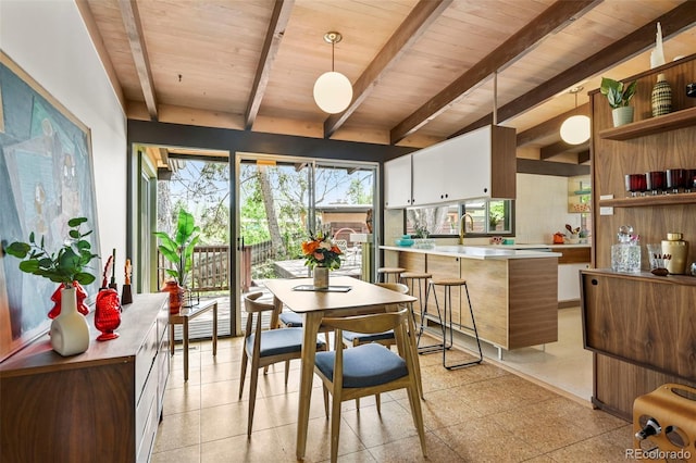 5450 Mohawk Rd, Littleton, CO 80123 - dining area with beamed ceiling, wooden ceiling, and light floors