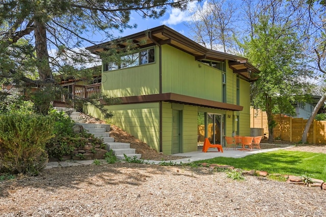 5450 Mohawk Rd, Littleton, CO 80123 - rear view of house featuring a patio area, fence, and stairs