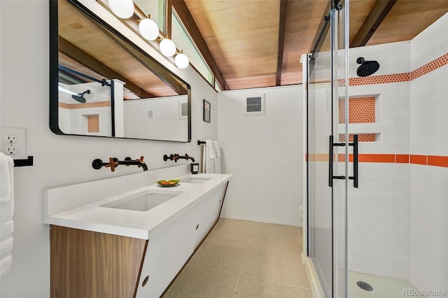 5450 Mohawk Rd, Littleton, CO 80123 - full bath with a stall shower, tile patterned floors, wooden ceiling, double vanity, and toilet