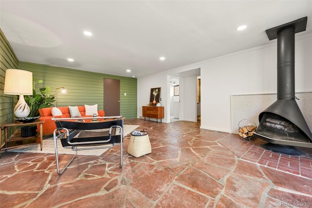 5450 Mohawk Rd, Littleton, CO 80123 - living room with stone flooring, a wood stove, recessed lighting, ornamental molding, and baseboards