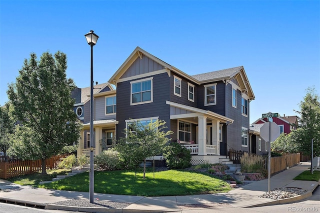 view of front of home featuring covered porch and a front yard