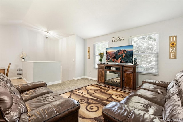 9605 Orangewood Dr, Thornton, CO 80260 - living room featuring healthy amount of natural light, carpet, baseboards, and lofted ceiling