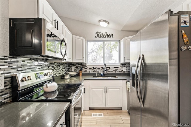 9605 Orangewood Dr, Thornton, CO 80260 - kitchen with stainless steel appliances, a sink, decorative backsplash, white cabinetry, and a textured ceiling