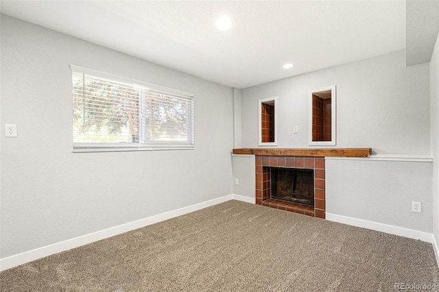 9605 Orangewood Dr, Thornton, CO 80260 - unfurnished living room featuring a tiled fireplace, baseboards, carpet flooring, and recessed lighting