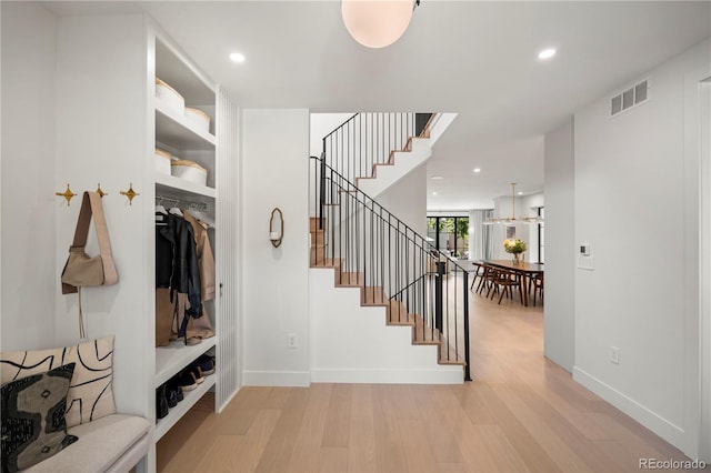 332 S Franklin St, Denver, CO 80209 - stairway featuring wood finished floors and recessed lighting