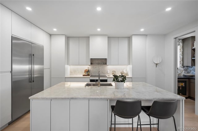 332 S Franklin St, Denver, CO 80209 - kitchen featuring stainless steel built in fridge, modern cabinets, tasteful backsplash, white cabinets, and recessed lighting